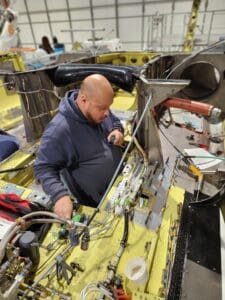 A man working on the side of a boat.